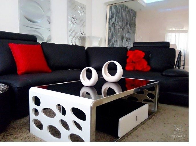 Shaped Sofa With Red Throw Pillows